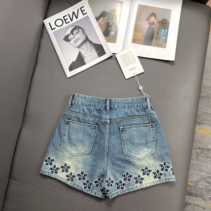 Camellia embroidered denim shorts