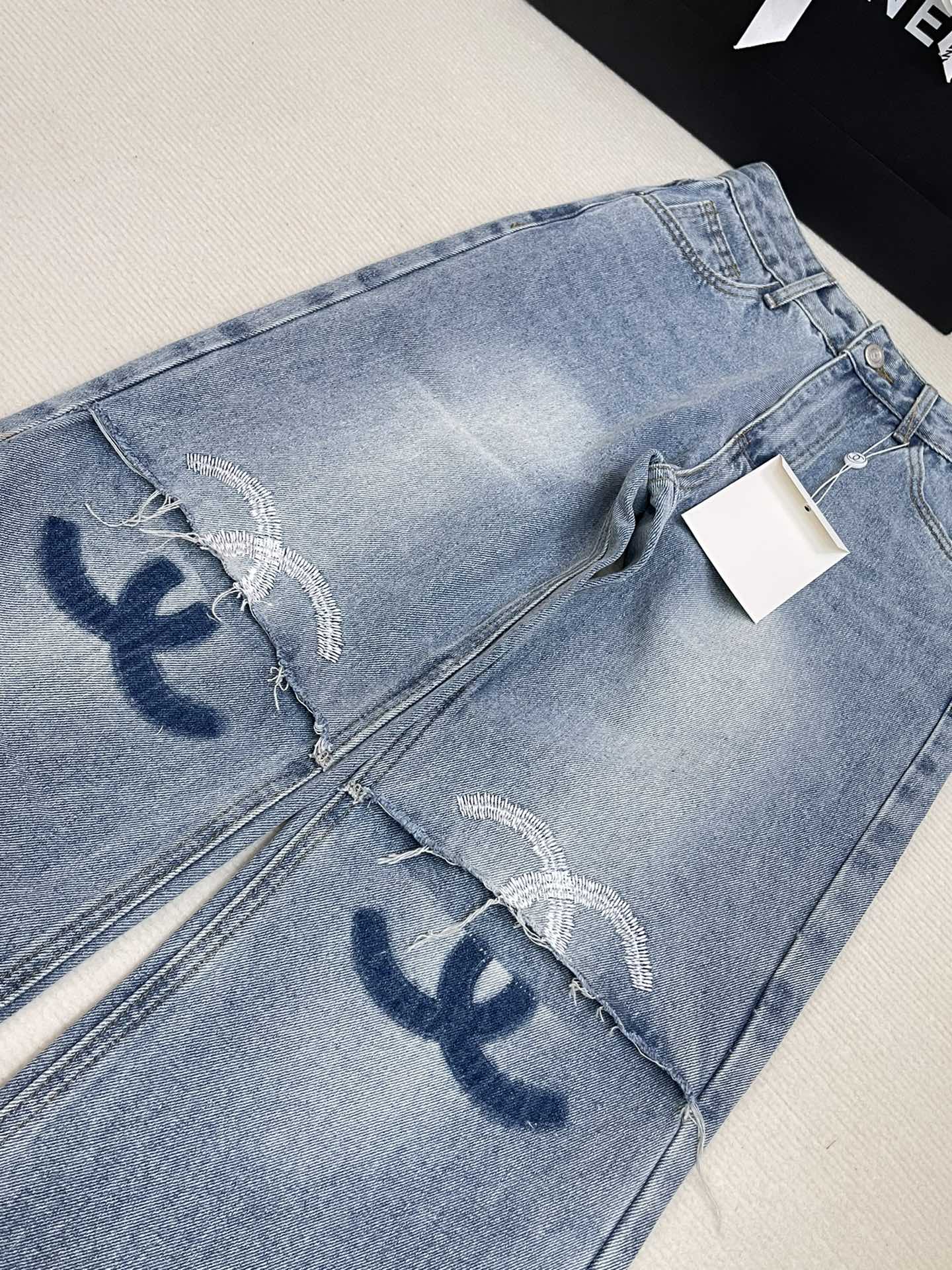 New shade embroidered ripped denim trousers